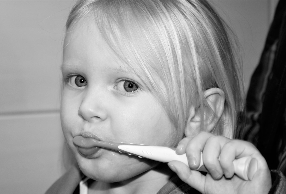 child brushing her teeth